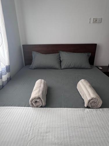 a bedroom with a bed with towels on it at Urban Nest Studio in Homagama