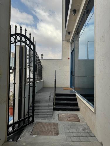a stairway with a black iron gate and stairs at Extraordinary 6 Bedroom Villa in Abu Dhabi - Group Getaway in Muşaffaḩ