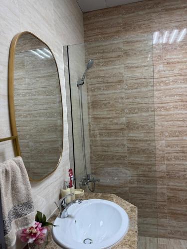 a bathroom with a sink and a mirror at Extraordinary 6 Bedroom Villa in Abu Dhabi - Group Getaway in Muşaffaḩ