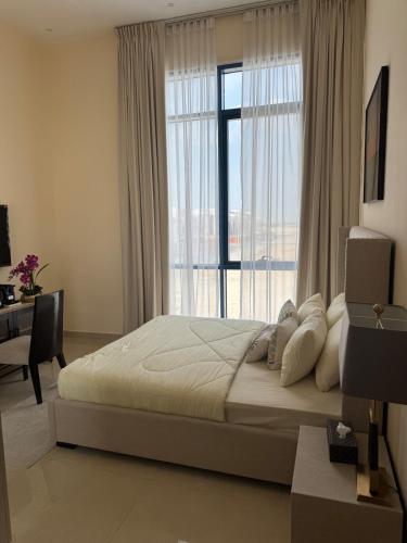 a bedroom with a large bed and a large window at Extraordinary 6 Bedroom Villa in Abu Dhabi - Group Getaway in Muşaffaḩ