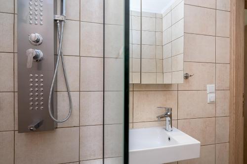 a bathroom with a sink and a shower at OliveHousesAXD in Mákri
