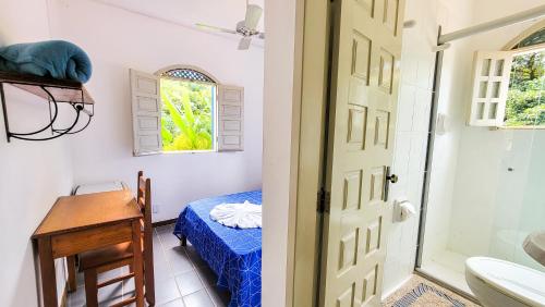 a bathroom with a bed and a sink and a door at BUONA SORTE in Lençóis