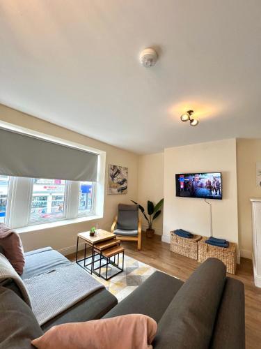 a living room with a couch and a tv at DVMescape flat1 in Bristol