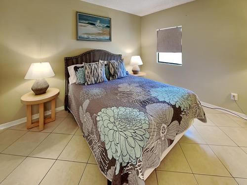 a bedroom with a bed and a table with lamps at Sunkissed Escape in Jacksonville Beach