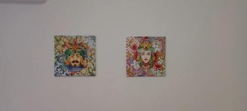 two paintings on a wall next to each other at Casa il cortile in San Cataldo
