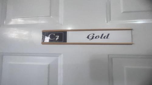 a door with a sign that says gold on it at C7 Hazelwood Residence & Suites in Abuja