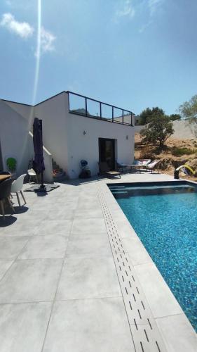 une villa avec une piscine dans le désert dans l'établissement Villa Isula Contemporaine, à Palasca
