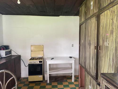 a kitchen with a stove and a table in it at Granja Picalquí in Tabacundo