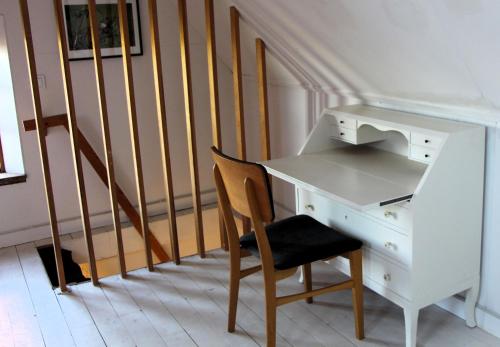 a desk and a chair next to a staircase at Solbacken in Bjärred