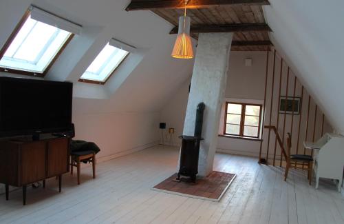 a living room with a fireplace in a attic at Solbacken in Bjärred