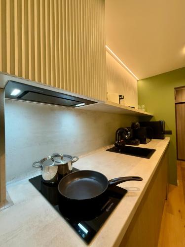 a kitchen counter with a frying pan on a stove at Jacuzzi Old Town Escape in Bucharest