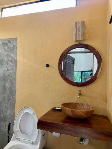 a bathroom with a wooden sink and a mirror at La Punta SurfHouse AC Starlink in Brisas de Zicatela