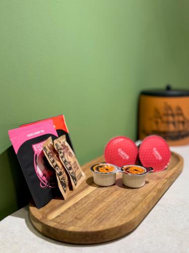 a wooden tray with snacks and balls on a table at Jacuzzi Old Town Escape in Bucharest