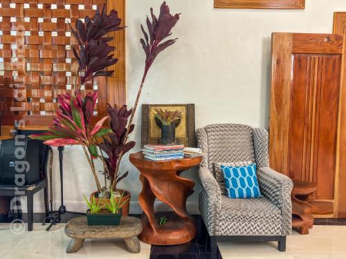 a living room with a chair and a table at Dragon's Lair B&B in Baguio