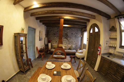 a living room with a wooden table and a fireplace at Vecchia Luna: The coziest spot in ValQuirico in Santeagueda
