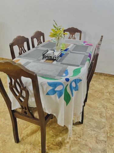a table with a table cloth on it with chairs at Fantasia Residence in Wattala