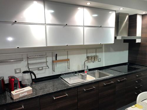 a kitchen with a sink and a counter top at Luxury Apartment near Beach & Golf in Amora