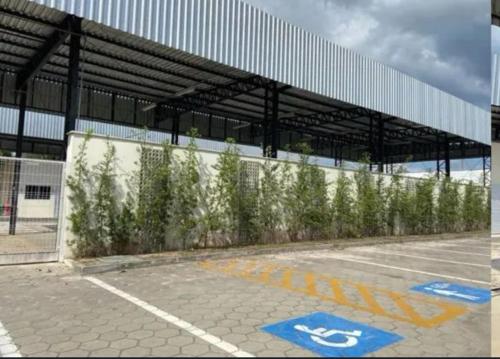 an empty parking lot with trees in front of a building at Casa disponível para a COP in Ananindeua