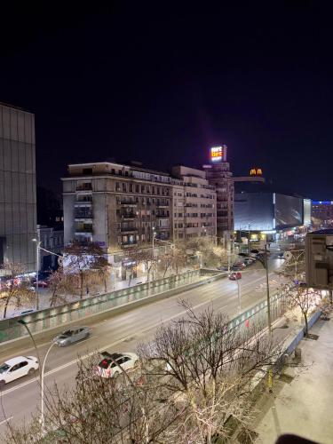 a city at night with cars driving on a highway at Jacuzzi Old Town Escape in Bucharest