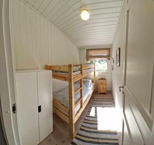 a small room with a bunk bed in a house at Cabin with lovely view in Lakså