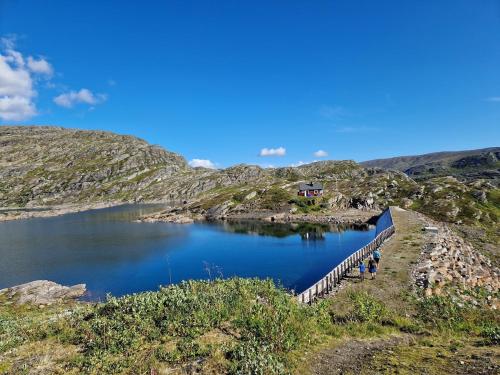 a lake in the middle of a mountain at Cabin with lovely view in Lakså