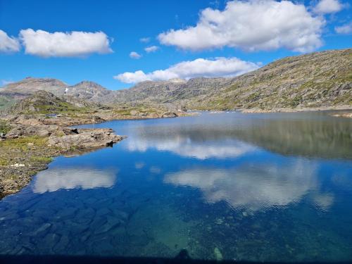 a large lake in the middle of a mountain at Cabin with lovely view in Lakså