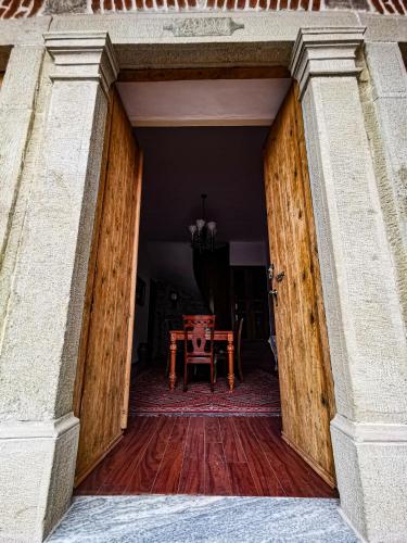 an open door into a dining room with a table at Domus Hotel in Korçë