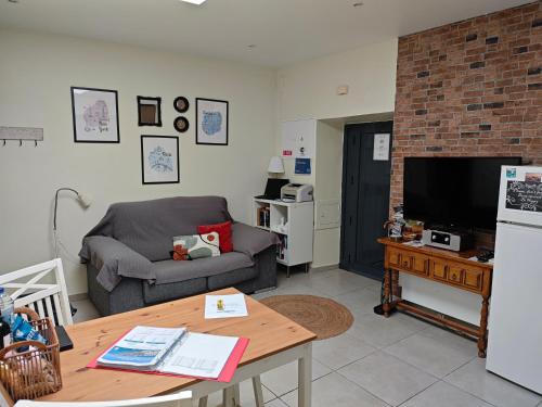a living room with a couch and a table at The Sunny Cottage by Freetimealgarve in Faro