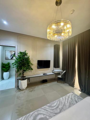 a large living room with a television and a chandelier at Nest 303 in Lekki