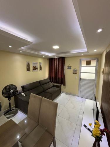 a living room with a couch and a table at Aconchego em Campo Grande - Guaratiba in Rio de Janeiro