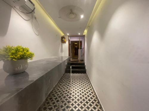 a hallway with a plant in a vase on a counter at Royal Casa Baga in Baga