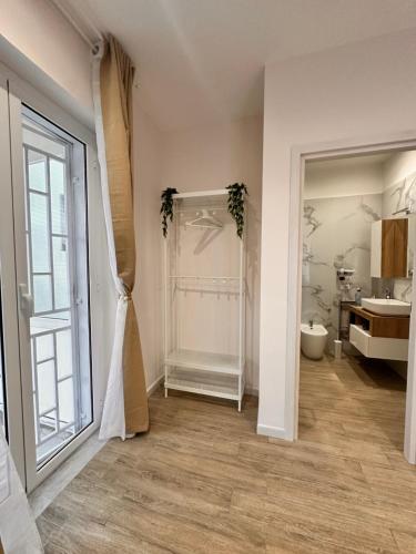 a room with a bathroom with a sink and a mirror at La dolce vita Napoli in Naples