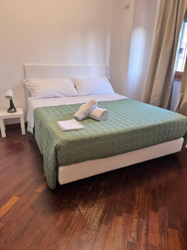 a bed with a towel on top of it at DOLCEVITA Eur Relax Home in Rome