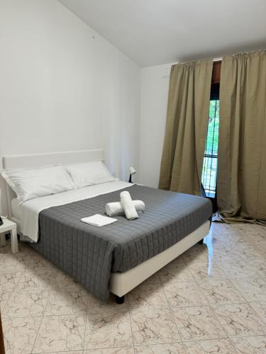 a bedroom with a bed with two white towels on it at DOLCEVITA Eur Relax Home in Rome
