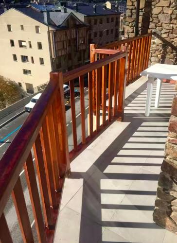 a wooden railing on a balcony of a building at Unique Duplex in La Massana