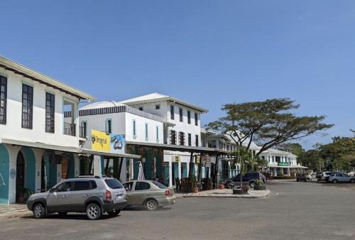 a street with cars parked in front of buildings at Alma y Paz Beach House in Bejuco