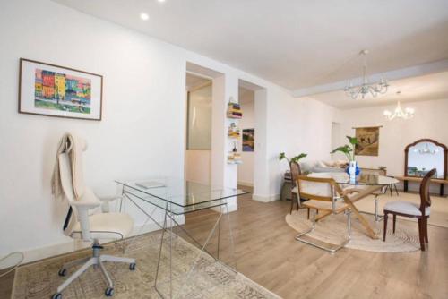 a living room with a glass table and chairs at Large terrace 3 minutes from the beach in Getxo