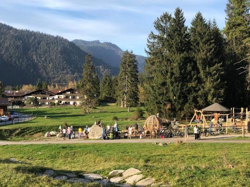 a group of people in a park with a playground at Ferienwohnung Farchanter Alm mit Schlafzimmer, Wohnzimmer und Schlafnische in Farchant