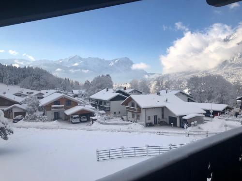 a view of a snow covered village with houses at Ferienwohnung Farchanter Alm mit Schlafzimmer, Wohnzimmer und Schlafnische in Farchant