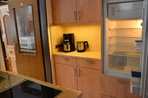a kitchen with a coffee maker sitting on a counter at Ferienwohnung Farchanter Alm mit Schlafzimmer, Wohnzimmer und Schlafnische in Farchant