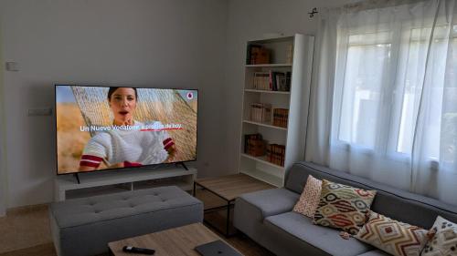 a living room with a large flat screen tv at Villa Carolina in Jávea