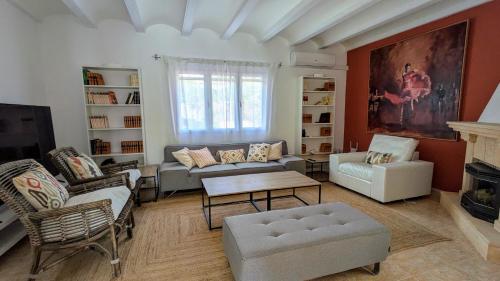 a living room with a couch and a table at Villa Carolina in Jávea