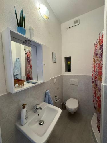 a bathroom with a sink and a toilet at Stanza Angeli in Nulvi