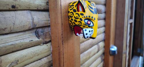 a wooden door with a paper cat head on it at Bio Coliving Tayrona in Santa Marta