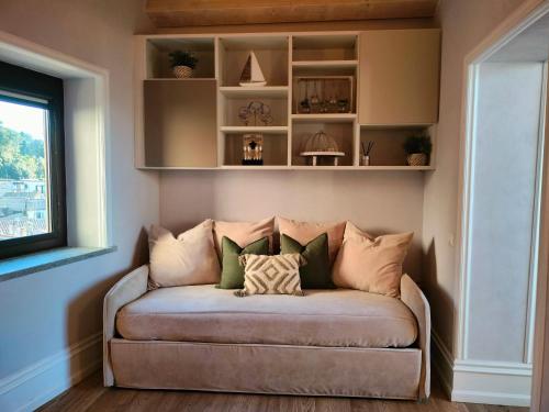 a couch in a room with a window at La Finestra tra le Stelle in Anguillara Sabazia