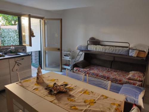 a room with a table and a bunk bed at apartment from Ire e Ale in Torre del Lago Puccini