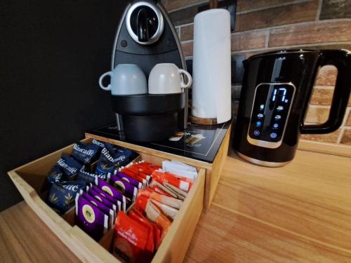 a coffee maker sitting on a table next to a box of food at Frabosa Loft in Turin