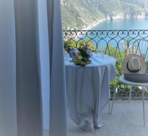 a table with a plate of food on a balcony at My Place Your Place in Corniglia