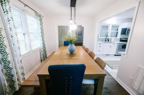 a dining room table with a blue vase on it at 5 Bedroom home near Parris Island, MCAS, Downtown Beaufort in Beaufort