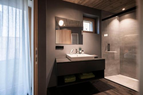 a bathroom with a sink and a shower at apartments arduus - high living in Naturno
